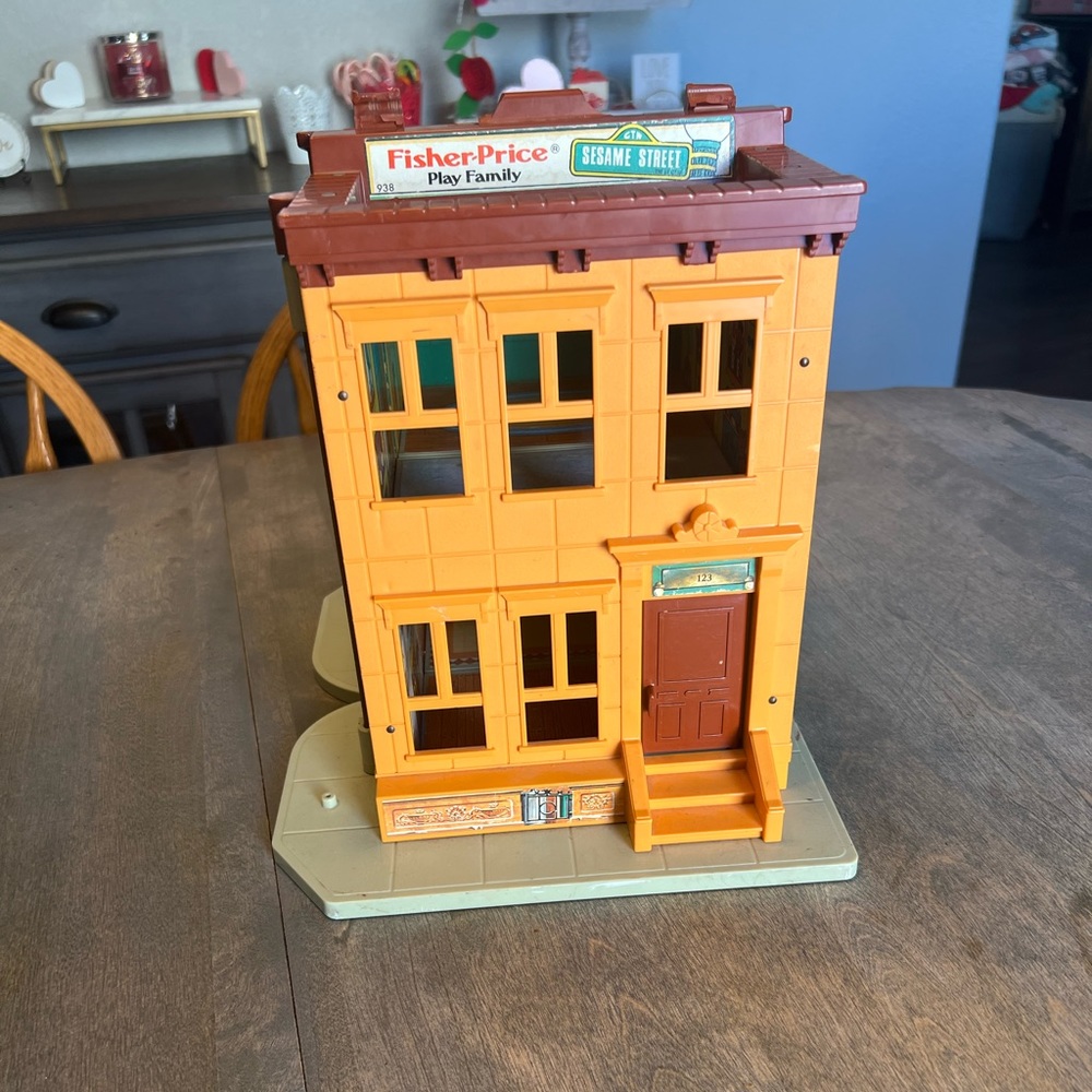 Vintage 1974 Fisher-Price Sesame Street clubhouse with figurines.